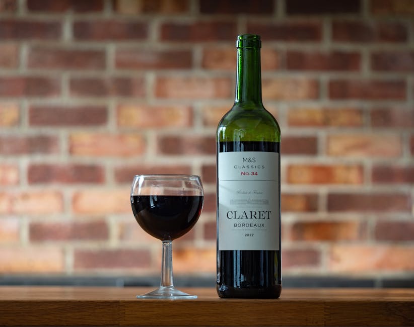 A Bordeaux-style red wine bottle and glass