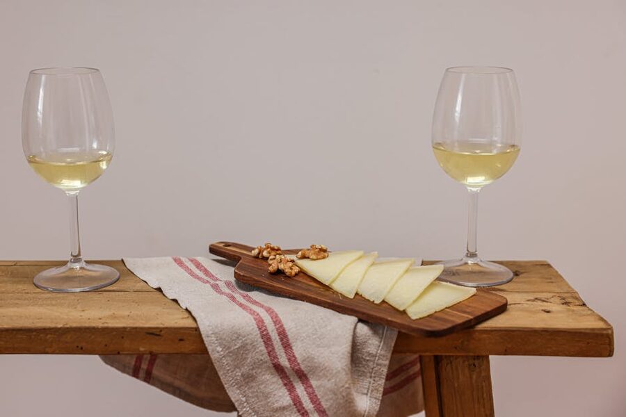 White wine and cheese on a board