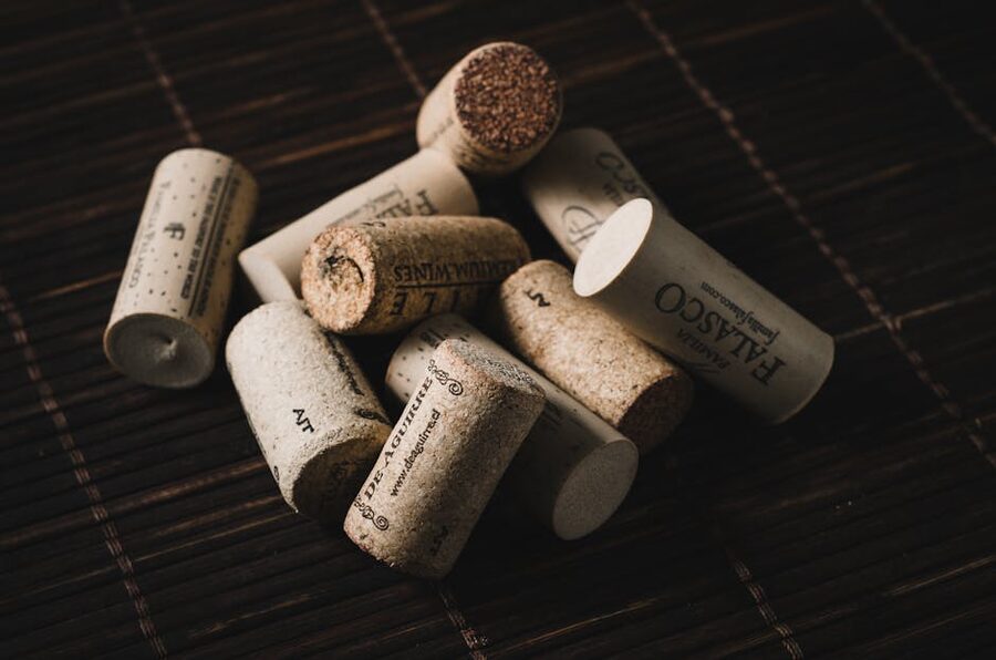 Close-up of wine bottle corks arranged on a dark wooden surface