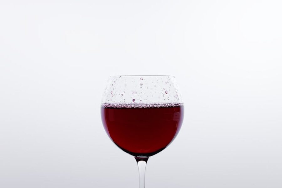 Red wine in a clean glass on a minimalist background