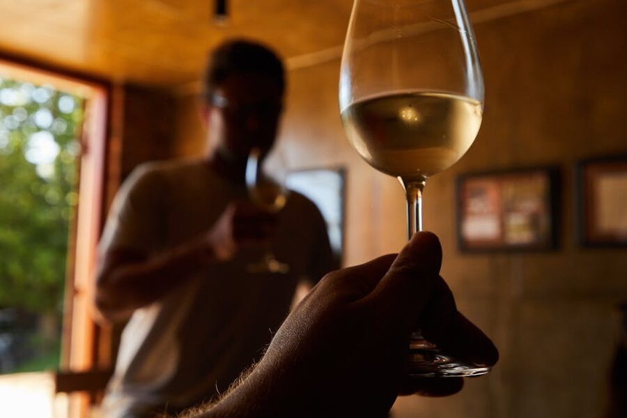 Two people enjoying white wine indoors at a Finger Lakes restaurant