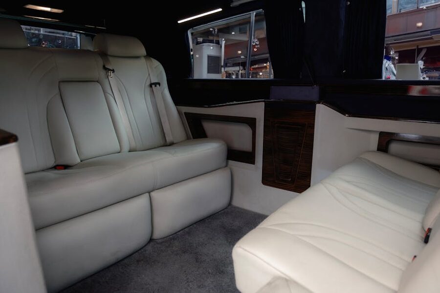 Mercedes-Benz van interior with white leather seats and wood paneling