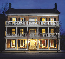 The Aurora Inn at night with lit windows