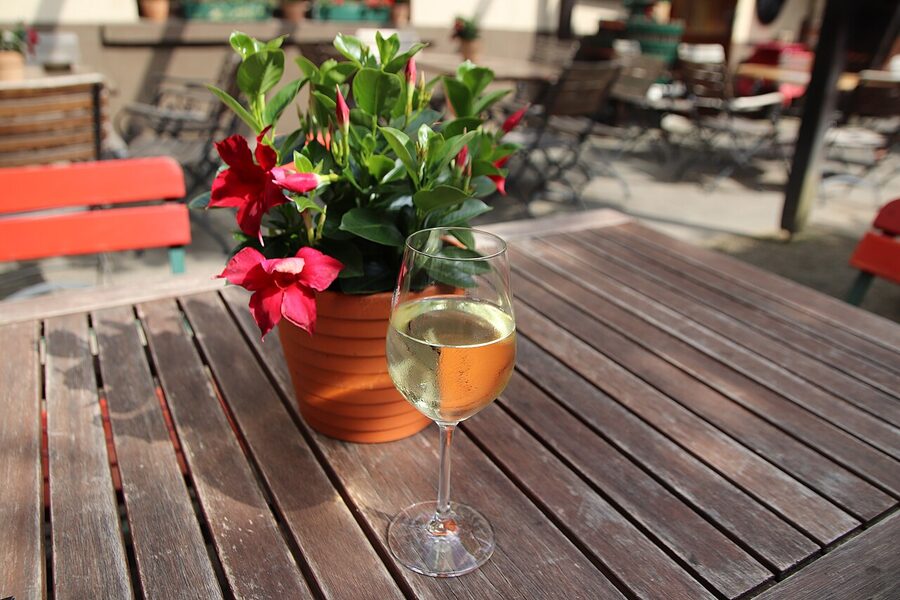 A glass of Riesling on a wooden table