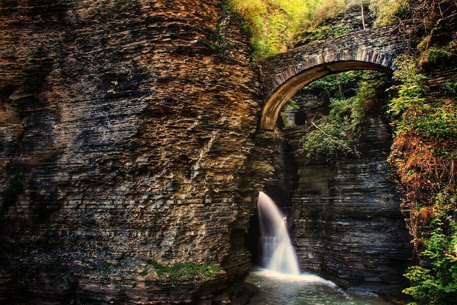 Waterfall under a stone bridge in Watkins Glen State Park