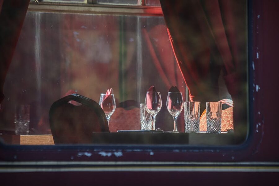 Vintage train carriage table setting with wine glasses