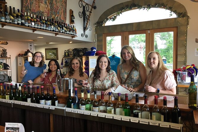 A small group at a Seneca Lake South wine tasting tour bar in the Finger Lakes