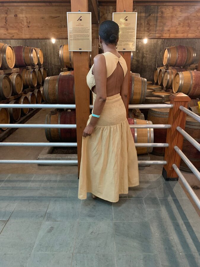 A branded wine glass on a North Fork tasting room patio in Cutchogue