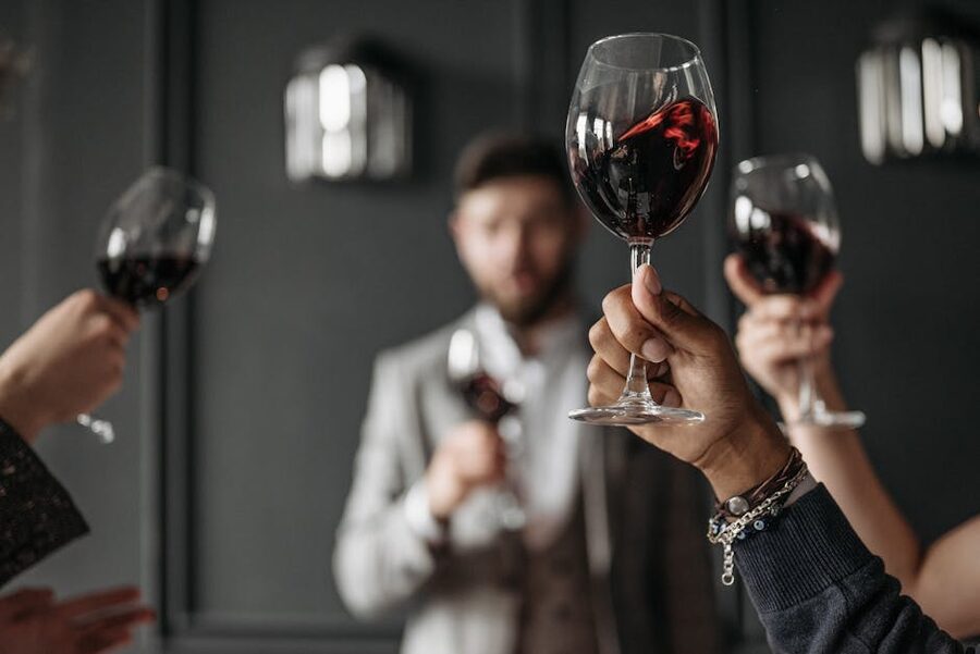 Friends toasting with red wine glasses